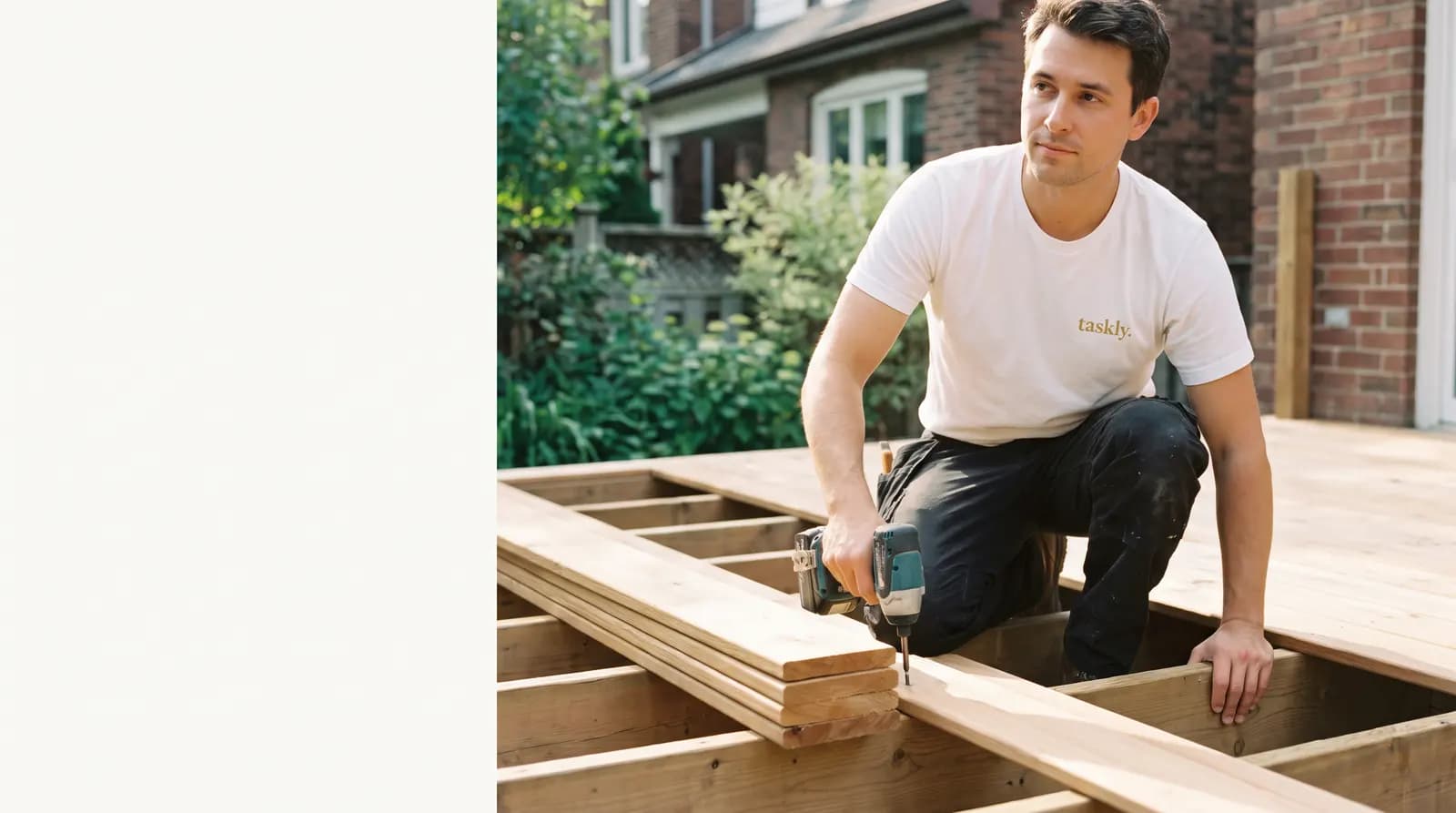 Deck boards being fastened down over joists at the back of a Toronto house.